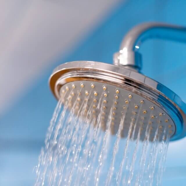 Shower head with refreshing cold water. Water supply is turned on